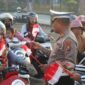 FOTO: Satuan Lalu Lintas (Satlantas) Polres Sampang saat membagikan bendera merah putih. @by_News9.id